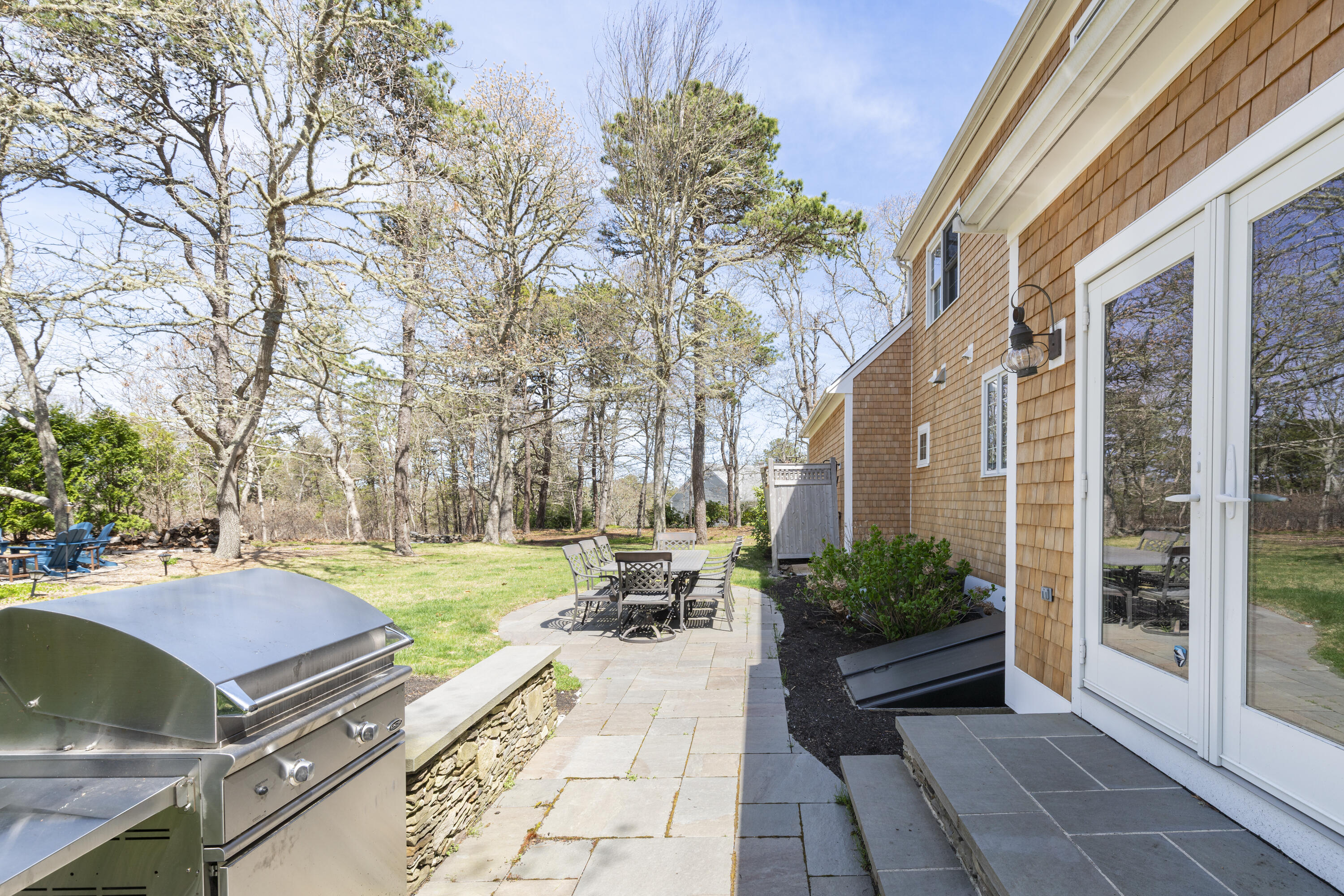 331 Riverview Drive Chatham, MA 02633 - Photo 49 of 50 a view of a patio with table and chairs and potted plants