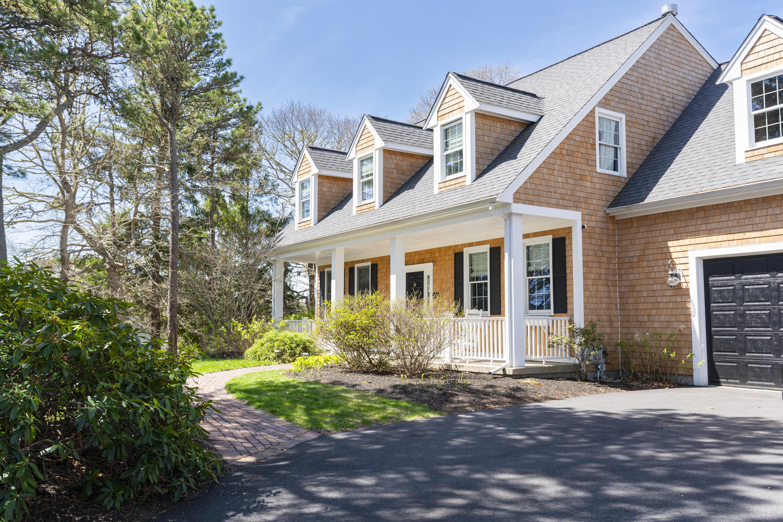 331 Riverview Drive Chatham, MA 02633 - Photo 10 of 50 a front view of a house with garden