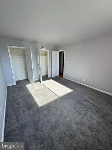 a view of wooden floor and windows in a room