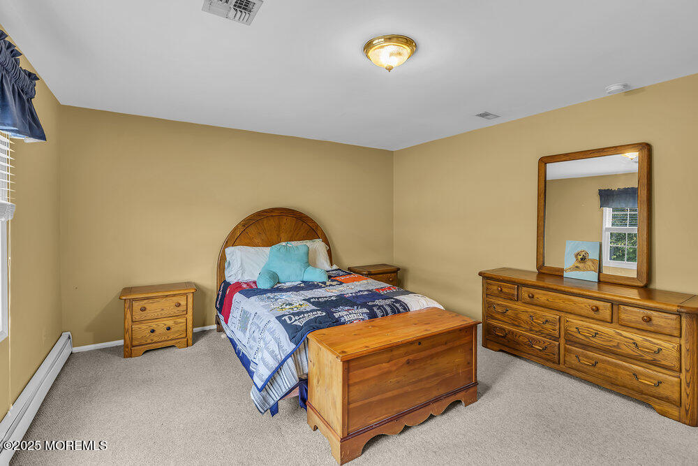 627 Reed Road Jackson, NJ 08527 - Photo 19 of 44 a bedroom with a bed and a dresser