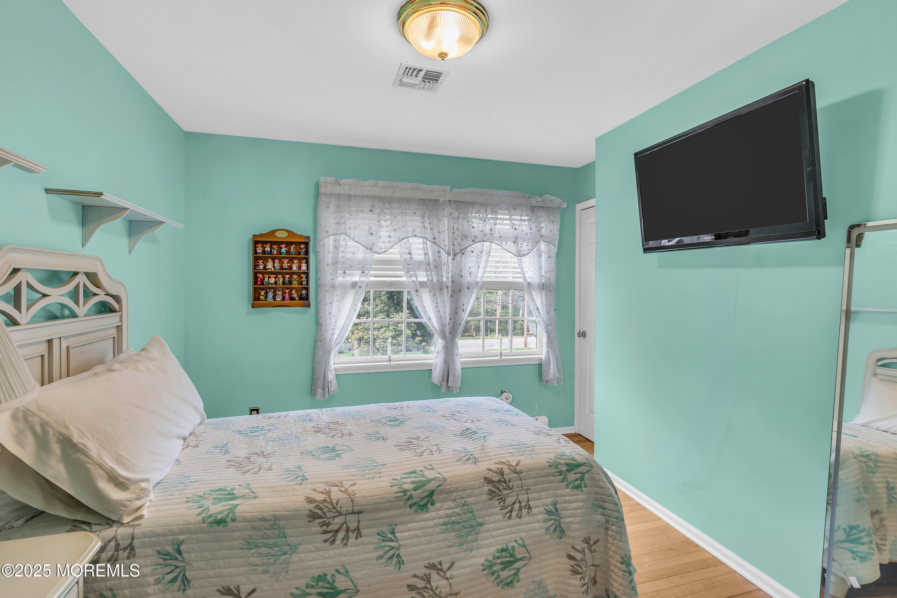 627 Reed Road Jackson, NJ 08527 - Photo 21 of 44 a bedroom with a bed and a flat screen tv