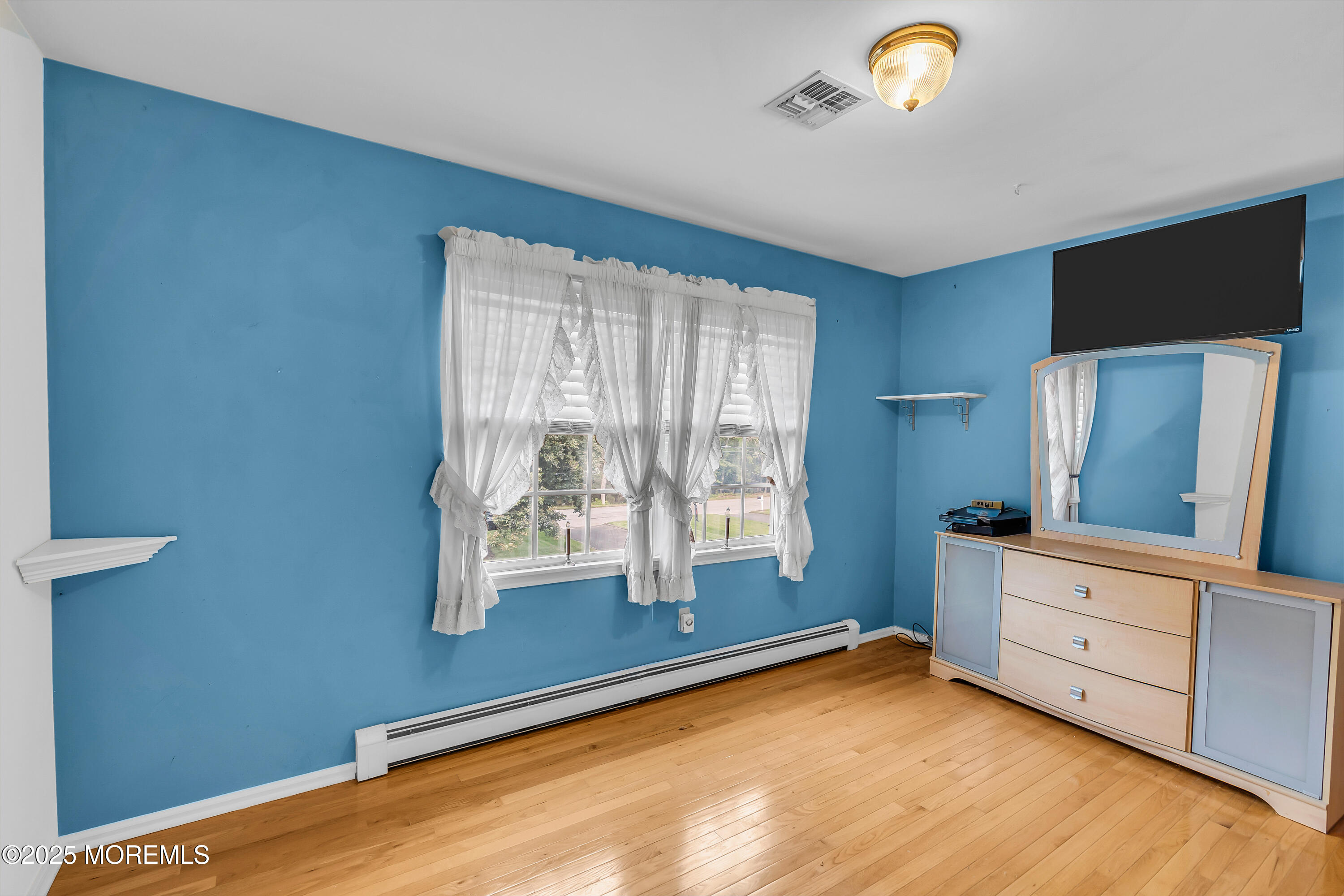 627 Reed Road Jackson, NJ 08527 - Photo 23 of 44 a room with window and a dresser