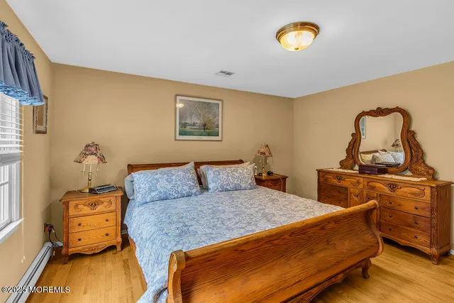 a bedroom with a bed and flat screen tv