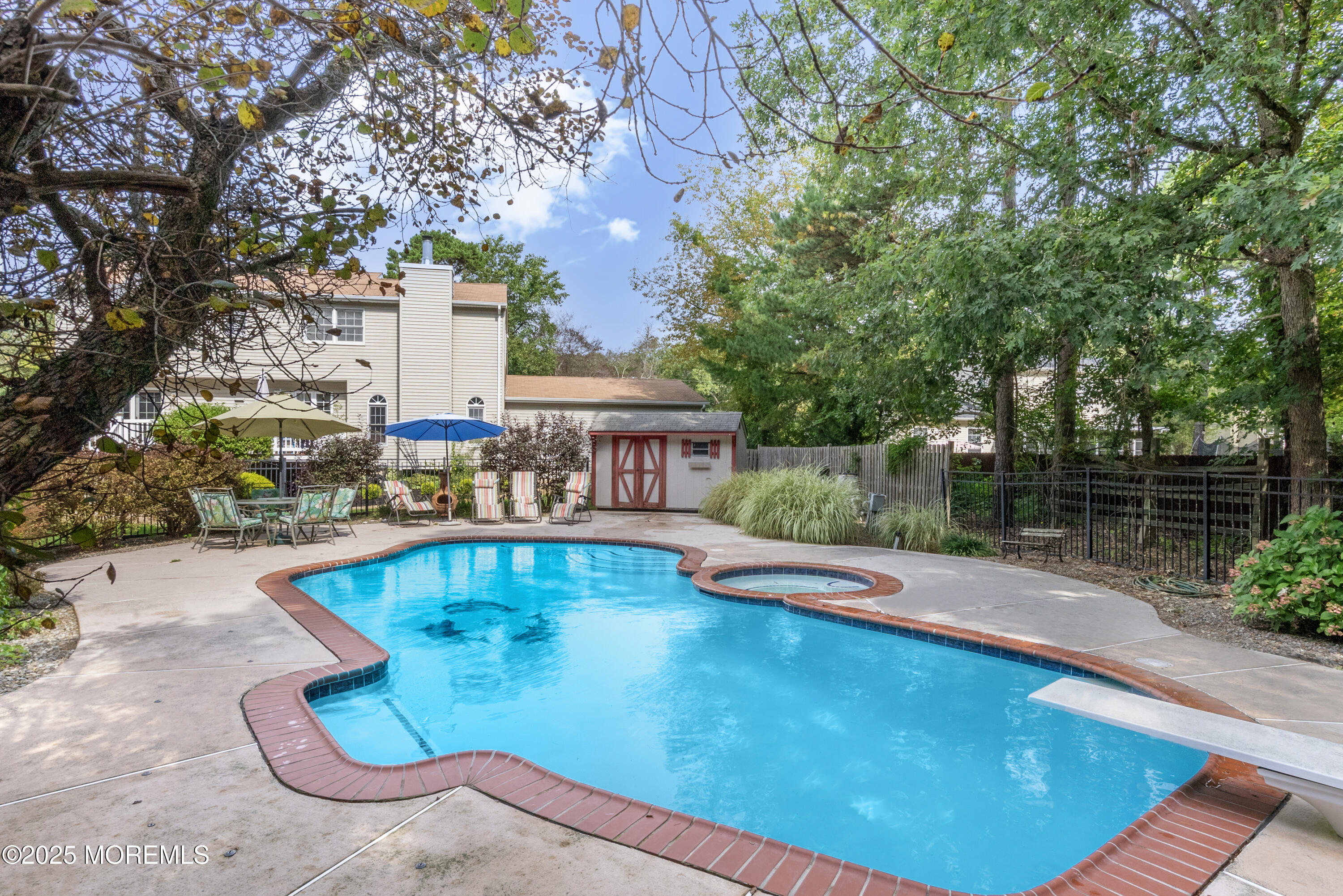 627 Reed Road Jackson, NJ 08527 - Photo 34 of 44 a view of a swimming pool with a patio