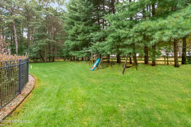 a view of a grassy field with trees in the background