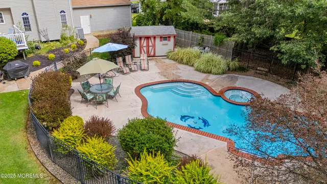 an aerial view of a house with a garden and swimming pool
