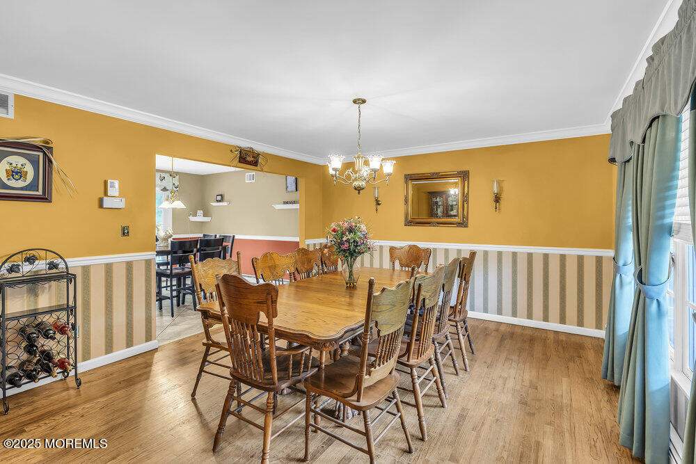 627 Reed Road Jackson, NJ 08527 - Photo 6 of 44 a view of a dining room with furniture and wooden floor