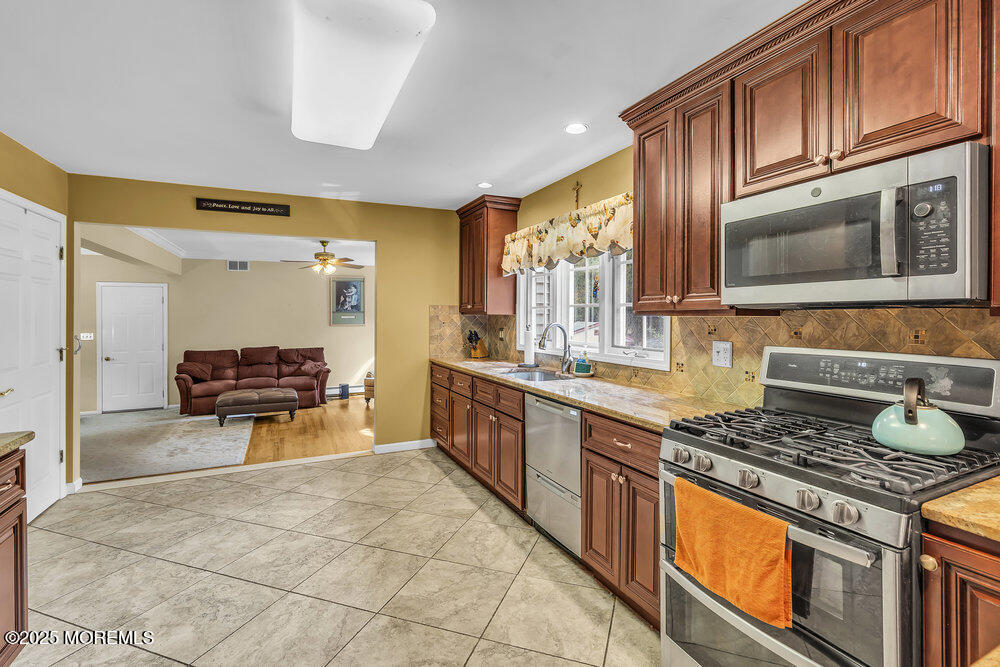 627 Reed Road Jackson, NJ 08527 - Photo 8 of 44 a large kitchen with stainless steel appliances granite countertop a stove and a sink