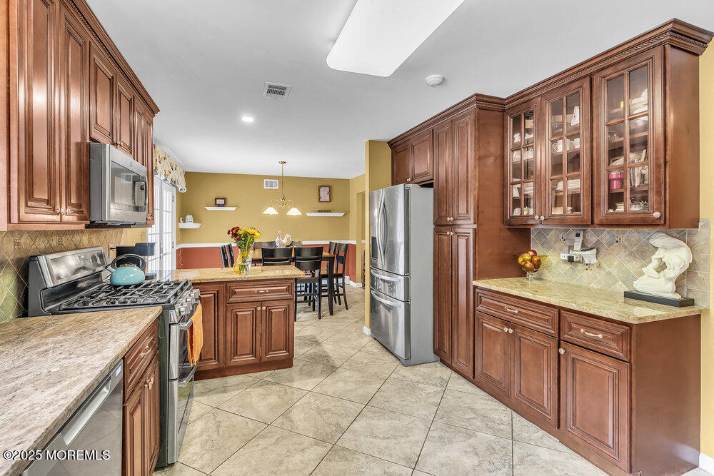 627 Reed Road Jackson, NJ 08527 - Photo 9 of 44 a kitchen with stainless steel appliances granite countertop a refrigerator stove and sink