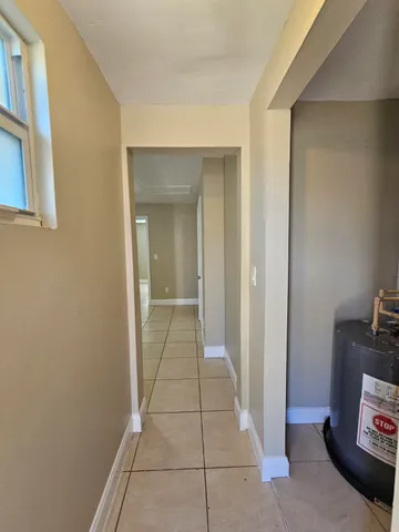 a view of a hallway to rooms