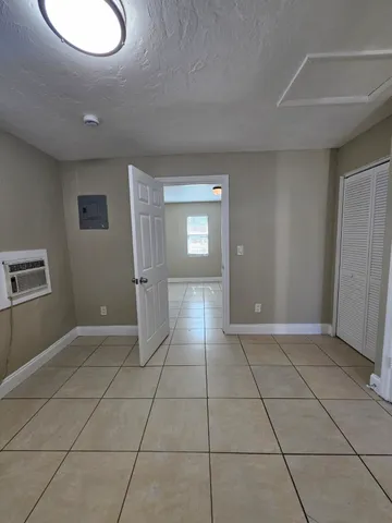 an empty room with windows and bathroom