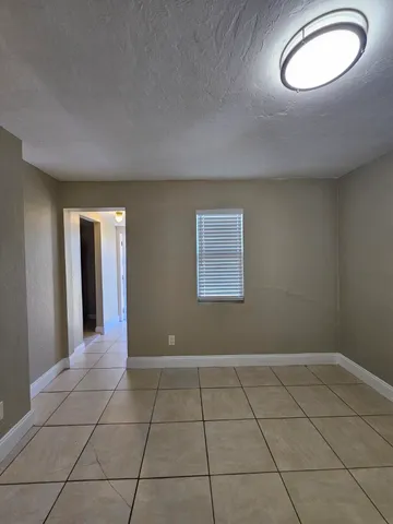 a view of a livingroom with an empty space and a window