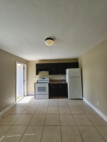 a kitchen with a stove top oven and cabinets