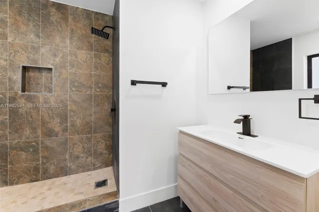 a bathroom with a sink a mirror and shower