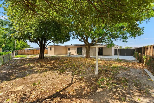 a house with trees in the background