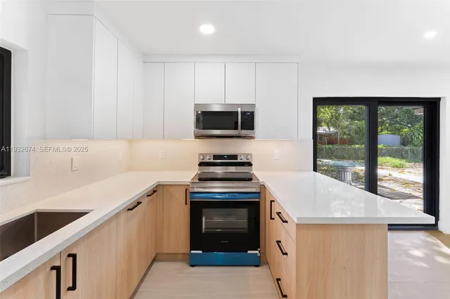 a kitchen with stainless steel appliances granite countertop a stove and a sink