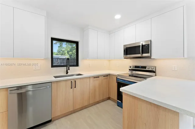 a kitchen with a sink and a stove