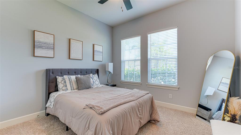 4511 Terrazza Court Lakewood Ranch, FL 34211 - Photo 22 of 65 a bed sitting in a bedroom next to a window