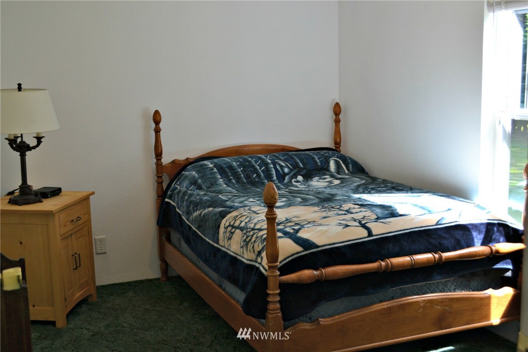 1462 North Fork Road Chehalis, WA 98532 - Photo 11 of 23 a bed sitting in a bedroom next to a window