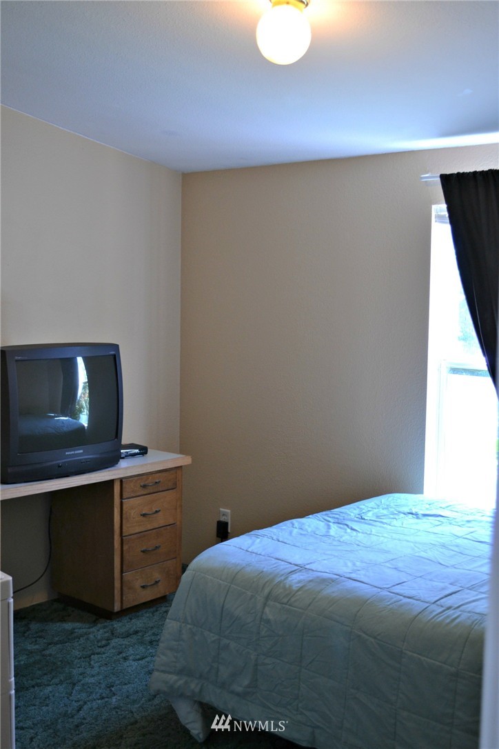 1462 North Fork Road Chehalis, WA 98532 - Photo 12 of 23 a bedroom with a bed and cabinets
