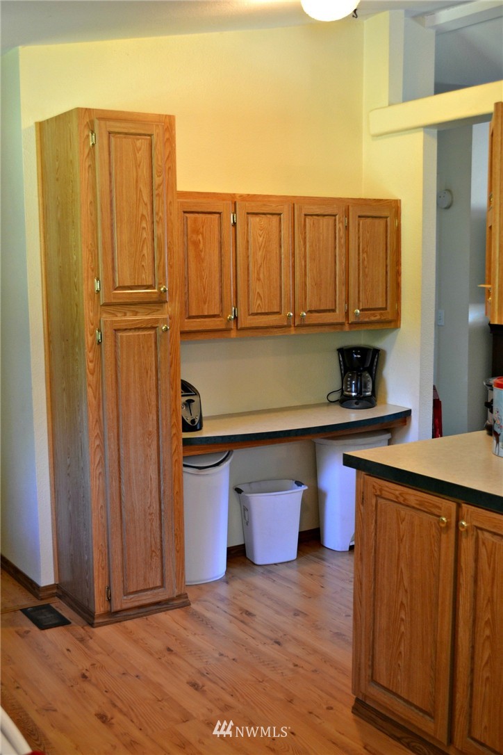 1462 North Fork Road Chehalis, WA 98532 - Photo 7 of 23 a kitchen with stainless steel appliances granite countertop a refrigerator a sink dishwasher and wooden cabinets with wooden floor