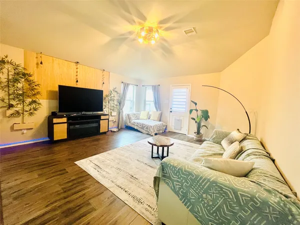 a living room with furniture and a flat screen tv