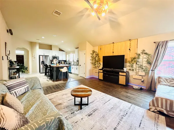 a living room with furniture and a flat screen tv