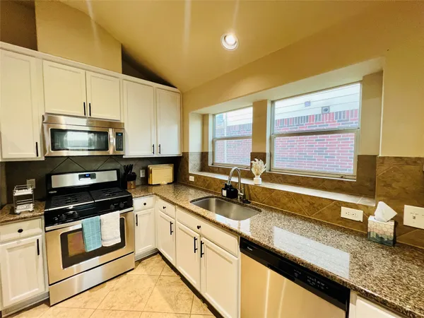 a kitchen that has a sink and a stove