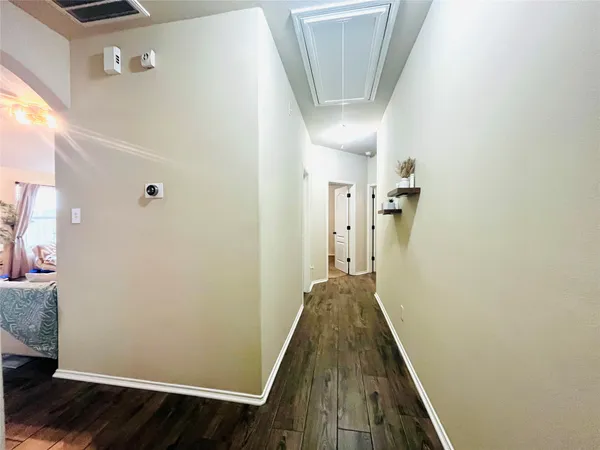 a view of a hallway with wooden floor and staircase