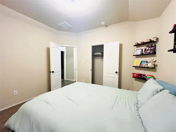 a bedroom with a bed and a closet