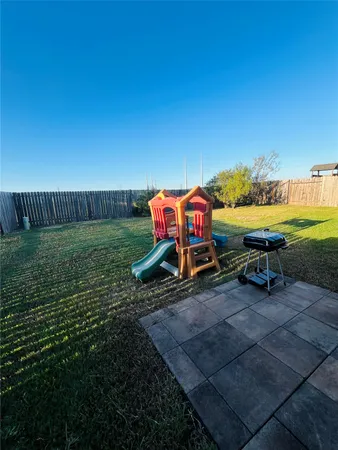 a view of a yard with table and chairs