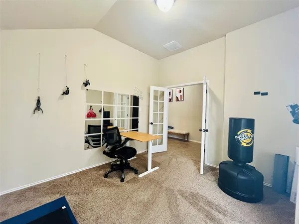 a view of a workspace with furniture and a window
