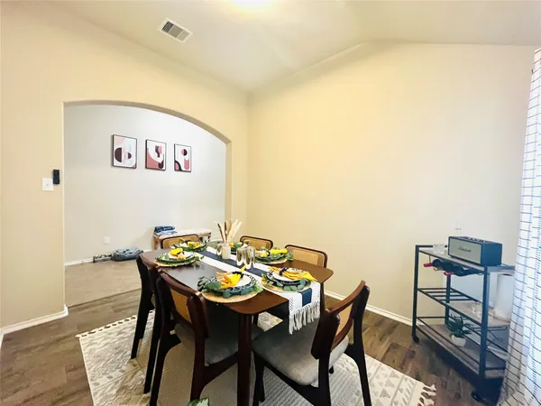 a view of a dining room with furniture and wooden floor