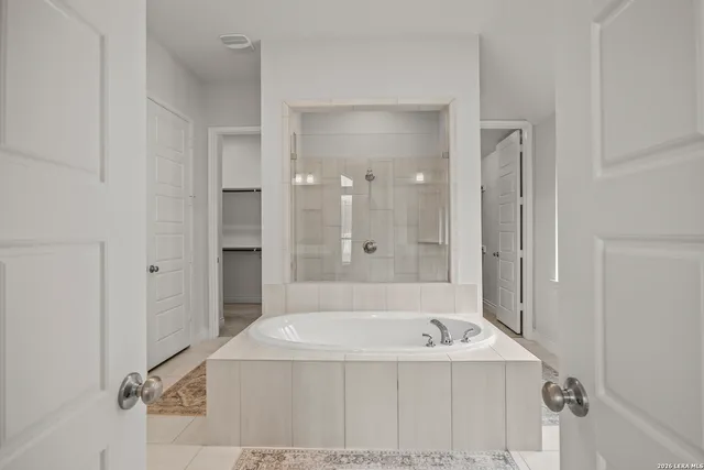 a bathroom with a bathtub and a shower