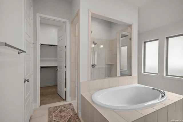 a bathroom with a tub a sink and a shower