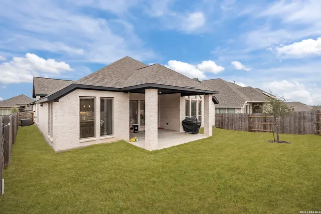 a front view of a house with yard and garage