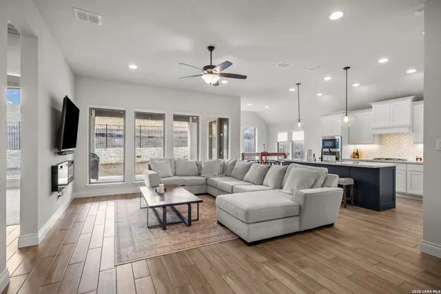 a living room with furniture fireplace and flat screen tv