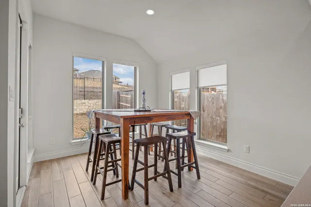 a view of a dining room with furniture and wooden floor
