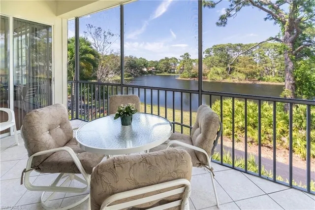a balcony with furniture and a potted plant