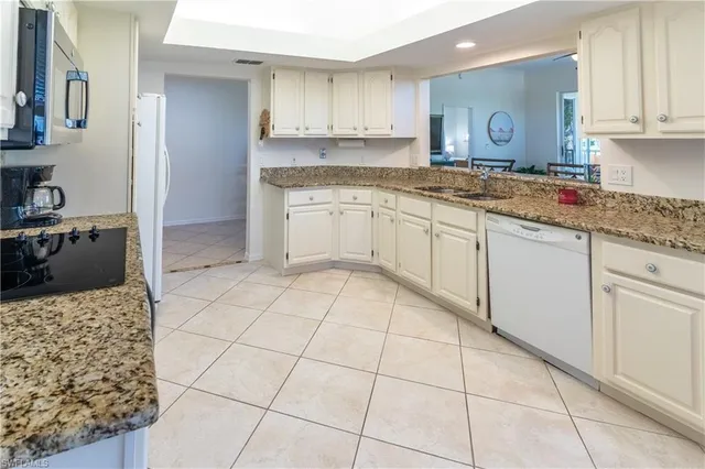 a kitchen with a stove a sink a refrigerator and cabinets