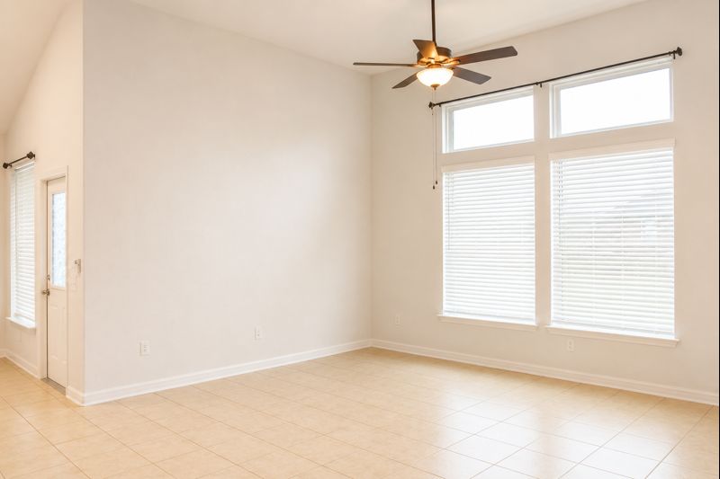 693 Durian Loop Buda, TX 78610 - Photo 11 of 27 Natural light pours into this spacious room, highlighting the clean lines and vaulted ceiling.