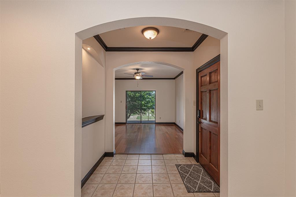1871 Signal Ridge Place Rockwall, TX 75032 - Photo 20 of 26 a view of a hallway with wooden floor and a living room