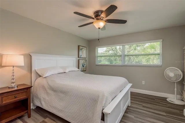 a bedroom with a large bed and a large window