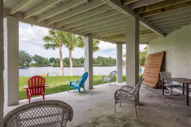 a view of a patio with a table chairs and a backyard