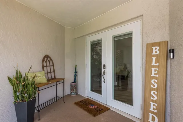 a view of living room filled with furniture and flower pot