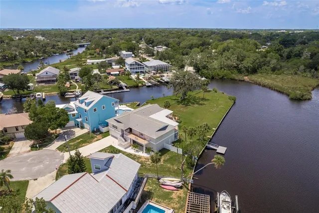 an aerial view of residential houses with outdoor space and street view