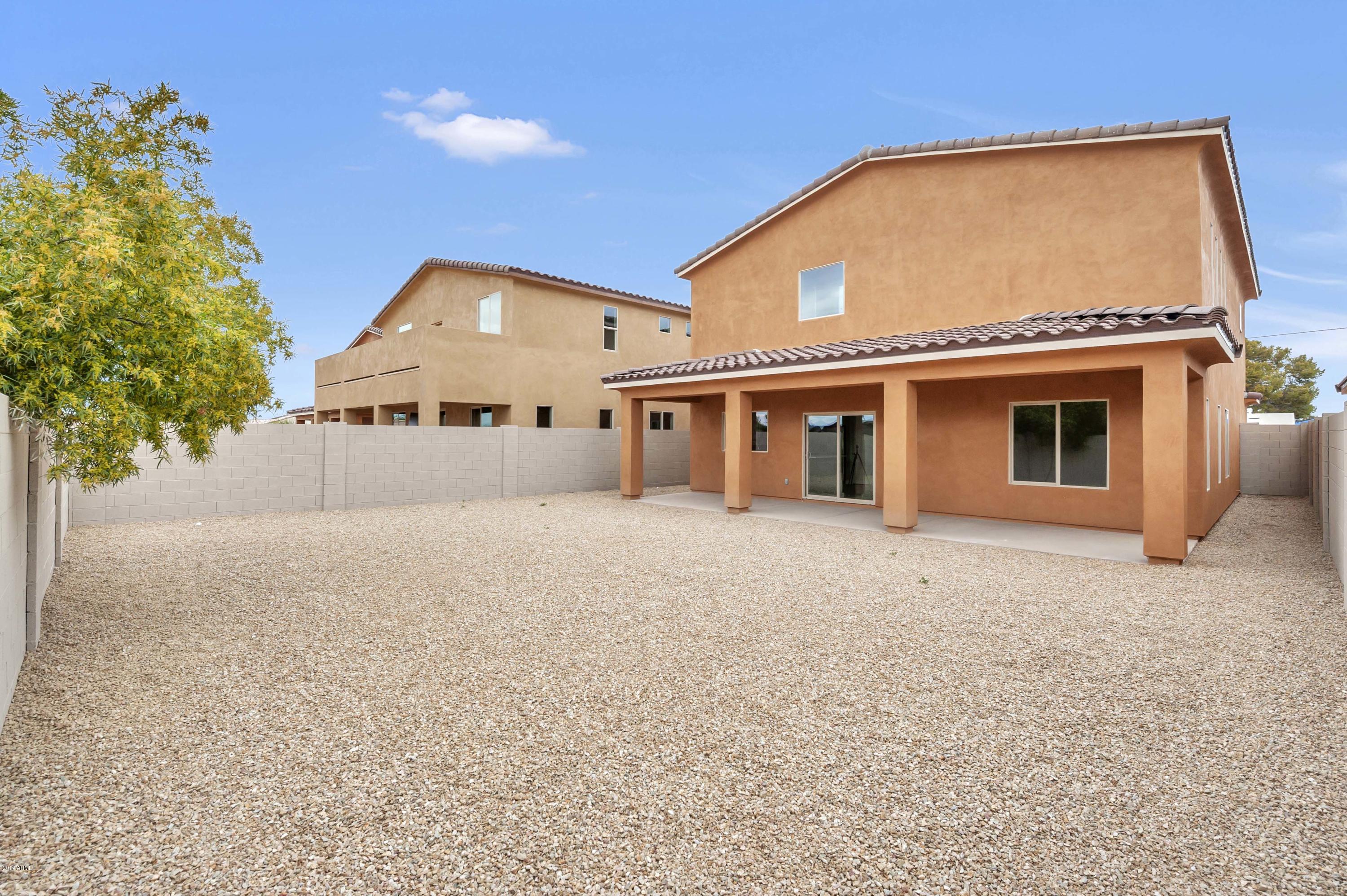2635 East Contention Mine Road Phoenix, AZ 85032 - Photo 2 of 11 a front view of a house with a yard and garage