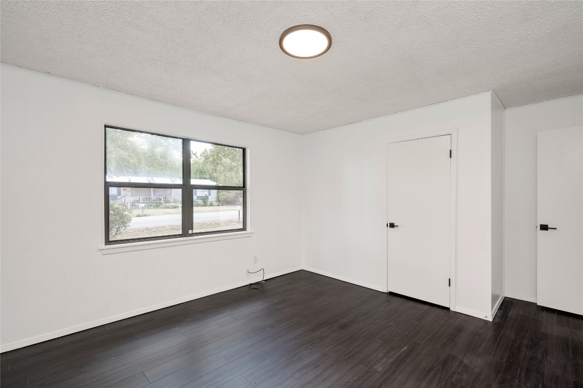 4948 Crossover Road San Marcos, TX 78666 - Photo 11 of 16 an empty room with wooden floor and windows
