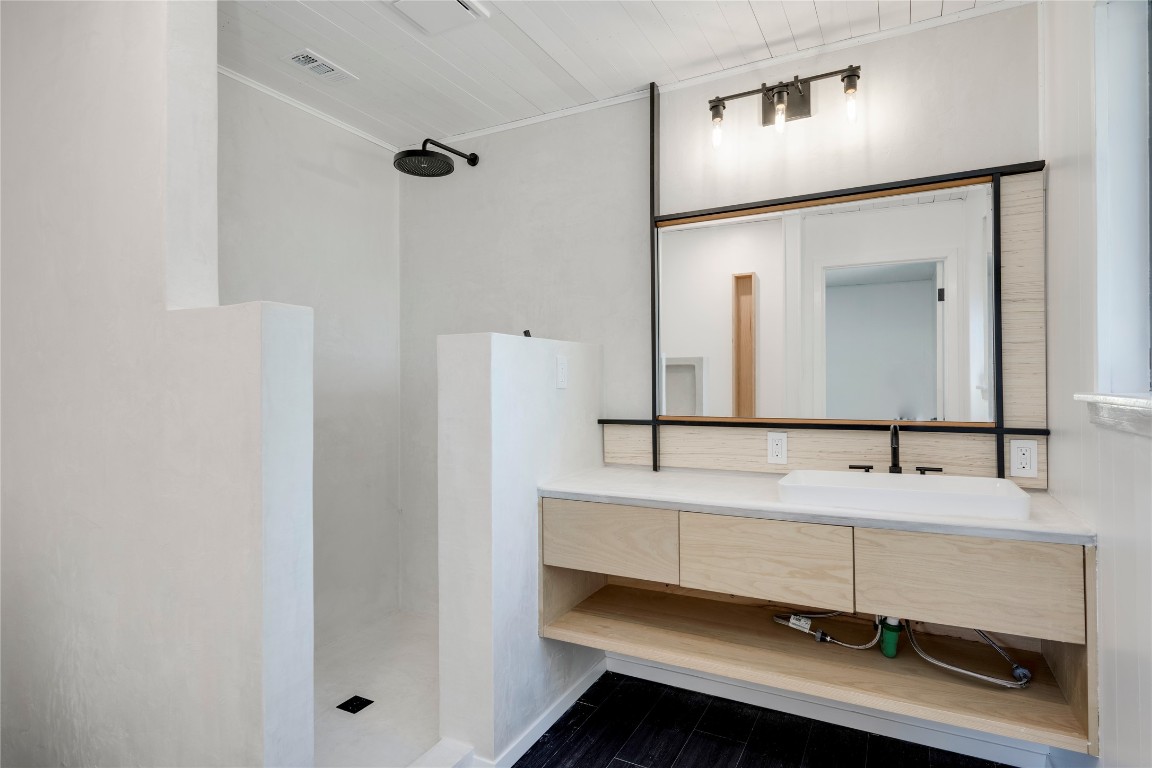 4948 Crossover Road San Marcos, TX 78666 - Photo 13 of 16 a bathroom with a sink and a mirror