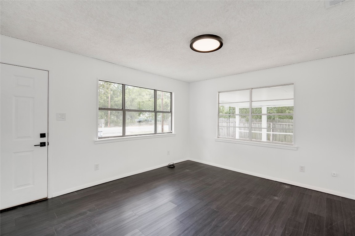 4948 Crossover Road San Marcos, TX 78666 - Photo 3 of 16 a view of an empty room with wooden floor and a window